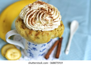 Banana Mug Cake Decorated With Whipped Cream.