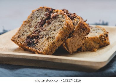 Banana Nutella Chocolate Cake On Wooden Plate Wit Mat-  Side View