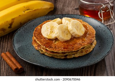 Banana oat pancakes topped with sliced ​​bananas and honey. - Powered by Shutterstock