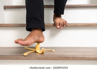 Banana Peels Are Placed On The Stairs Of The House To Risk Accidents. The Young Man Was About To Step On A Banana Peel And Slipped And Was Injured.