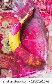 Banana in pink paint. Fluid with banana. Bright colors in the photo.