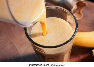 A Banana Shake Is Prepared On A Wooden Board.