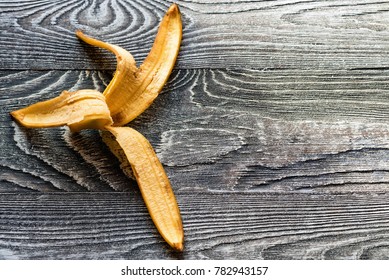 Banana skin lying on a wooden surface