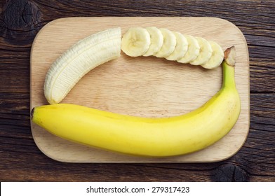 Banana And A Sliced On Cutting Board, Top View