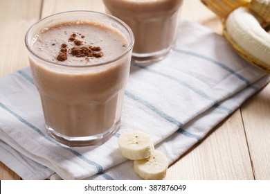 Banana Smoothie With Cocoa On Wooden Background