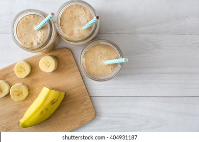 Banana smoothie on a white wooden table
 - Shutterstock ID 404931187