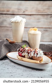 Banana Split Dessert With Nuts And Syrup With Milkshakes