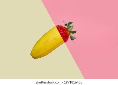 Banana And Strawberry On Pastel Pink And Yellow Background. Creative Split Screen Fruit Concept. 