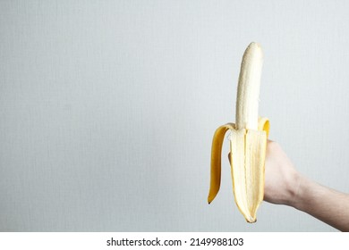 Banana as a symbol of the male penis in the hand. Sexual masturbation and orgasm, impotence problem. The concept of self-satisfaction.