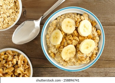 Banana Walnut Overnight Oatmeal In A Bowl On Wood Table, Overhead View