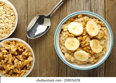 Banana Walnut Overnight Oatmeal In A Bowl On Wood Table, Overhead View