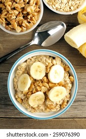 Banana Walnut Overnight Oatmeal In A Bowl On Wood Table, Overhead View