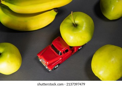 Bananas And Apples And A Red Toy Truck