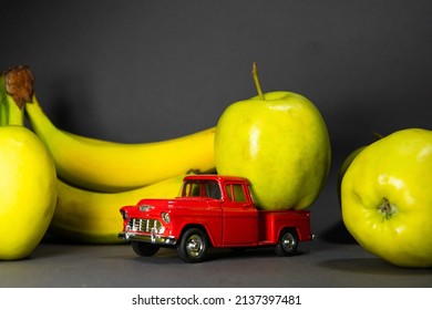 Bananas And Apples And A Red Toy Truck