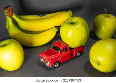 Bananas And Apples And A Red Toy Truck