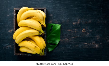 Bananas on a black wooden surface. Tropical Fruits. Top view. Free copy space. - Powered by Shutterstock