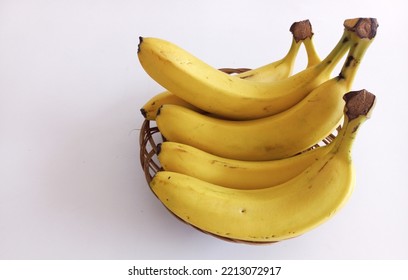 Bananas Served On A Rattan Plate On A White Background