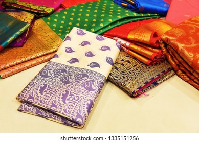 Banares Silk Saris In A Textile Shop,  Displayed In Front Of Customers. These Exquisite, Expensive Sarees Are Famous For Their Gold And Silver Zari, Brocade. Incredible India.