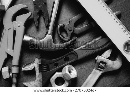 banch of different hand tools over workplace black and white