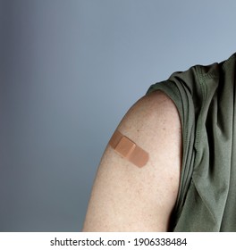 Band Aid On Male Upper Arm After Coronavirus Vaccine Shot 