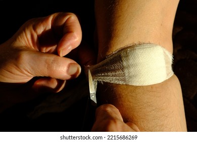 Band Aid Is Removed After Injection By Old Womans Hands Of Nurse. Blood Stain, The Bandage After Injection . Man Arm , Medical Concept Bundage Removing.