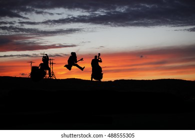 Band Performing Live During Sunset At Outside Concert