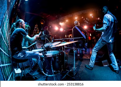 Band Performs On Stage, Rock Music Concert. Warning - Authentic Shooting With High Iso In Challenging Lighting Conditions. A Little Bit Grain And Blurred Motion Effects.