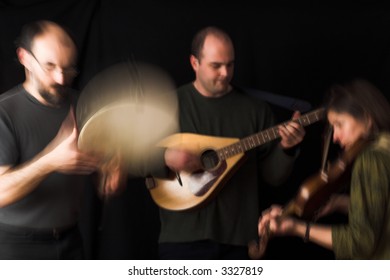 band playing celtic music over black background - blur effect