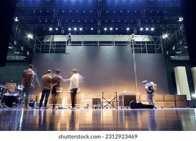 band preparing for show on stage when LED backdrop under in concert hall
