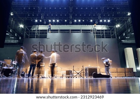 band preparing for show on stage when LED backdrop under in concert hall