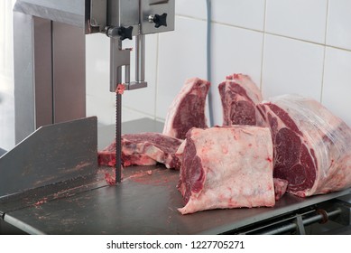 band saw cuts meat in a meat shop - Powered by Shutterstock