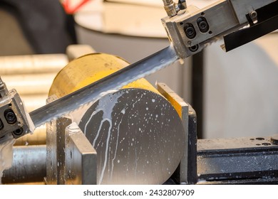 The band saw cutting machine cut the metal shaft parts with liquid coolant method. The machine tool for industrial purpose. - Powered by Shutterstock