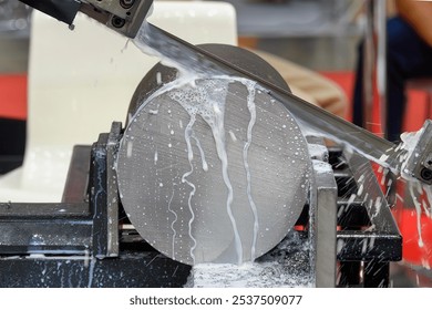 The band saw cutting machine cutting the metal shaft parts with coolant method. The machine tool for industrial purpose. - Powered by Shutterstock