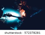 Band Silhouette. View of stage during rock concert with musical instruments and scene stage lights, rock show performance. Guitarist plays solo on stage. Electric guitar.