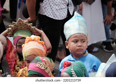 Banda Aceh, Indonesia - August 20, 2022: Selective Focus. This Is A Little Boy In Blue Traditional Clothes With A Slightly Panicked Face