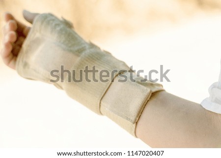 Bandage on the girl's hand. Recovery after a fracture of the hand.