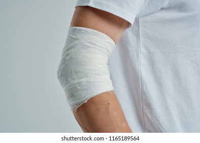 bandaged elbow on a gray background                            - Shutterstock ID 1165189564