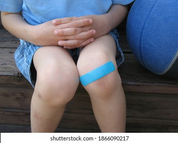 Bandaid On A Young Child’s Scratched Knee