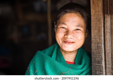 BANDARBAN, BANGLADESH - DECEMBER 25, 2021: Travel Reportage Portrait Of A Young Smiling Lady With A Green Scarf Of The Indigenous Tribal People Of The Rural Village Area In The South Of Bangladesh