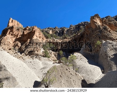 Bandelier National Monument in New Mexico. Hot ash from volcano at Valles Caldera cooled and welded into a rock called tuff. Pajarito Plateau and Frijoles Canyon show Volcanic Geology.  Stock photo © 
