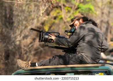 Bandhavgarh, Madhya Pradesh,  India - 25 April 2022 : Wildlife Cinematographer Or Photographer Above On Safari Vehicle Filming Or Shooting Wild Tiger And Her Cubs Or Panthera Tigris In National Park