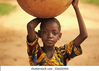 Bandiagara, Mali, Africa - August 27, 2011  Dogon Tribe Girl Carrying Water Home