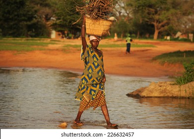 Bandiagara, Mali, Africa - August 27, 2011 Pregnant woman carrying firewood for their home 