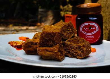 Banding, Indonesia- September 2022: A Jar Chili Oil With Popular Street Food Of Deep-fried Bean Curd From Sumedang, West Java. 