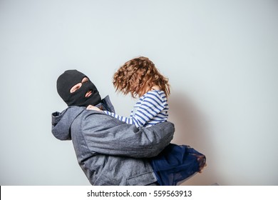 Bandit In Balaclava Stolen Child. Child Abduction. Stealing Kidnapped