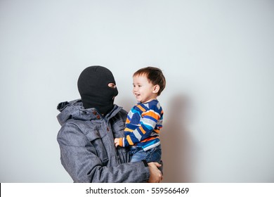 Bandit In Balaclava Stolen Child. Child Abduction. Stealing Kidnapped