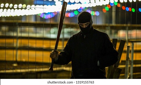 Bandit With Baseball Bat In Hand In The Park.
 
