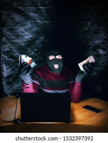 A Bandit In A Mask Of A Balaclava Using A Laptop Does Not Fair Profit On The Internet