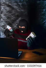 A Bandit In A Mask Of A Balaclava Using A Laptop Does Not Fair Profit On The Internet