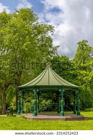 Bandstand set in beautiful woodland park with blue sky and vibrant trees. Foto stock © 